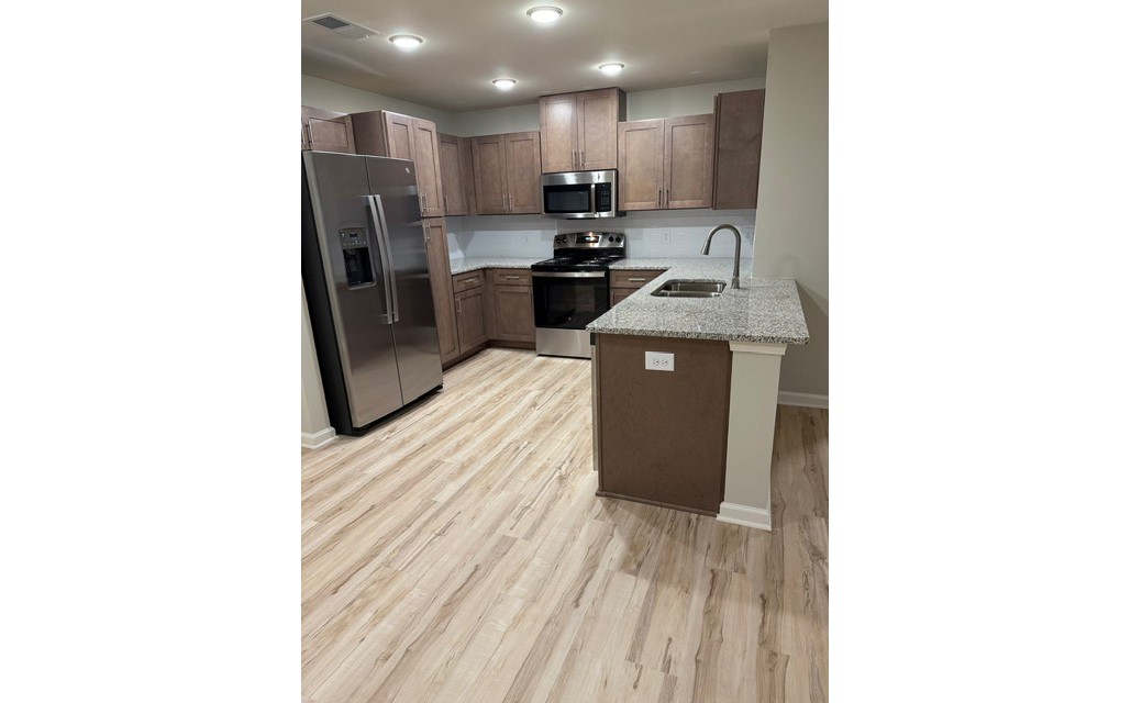 3432 Carr Road Durham, NC 27703 - Photo 26 of 28 a kitchen with stainless steel appliances a refrigerator and a sink