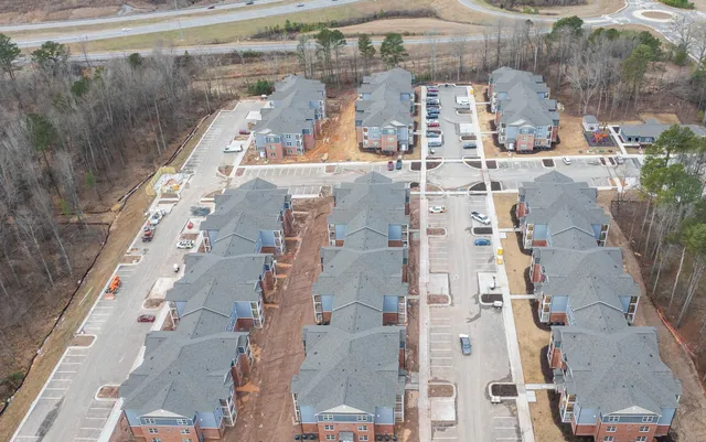 a house that has a wooden floor next to a yard