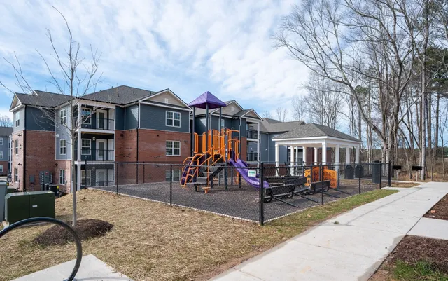 a front view of a house with wooden fence