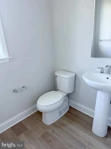 a white toilet sitting next to a white sink