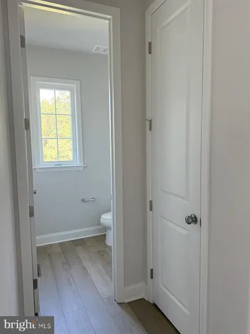 a view of a room with wooden floor and a window