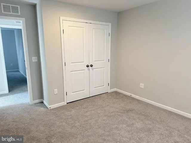 an empty room with closet area