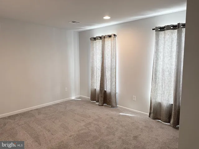 an empty room with closet and a window