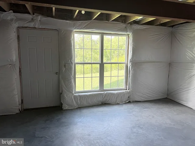 a view of walk in closet with clothes