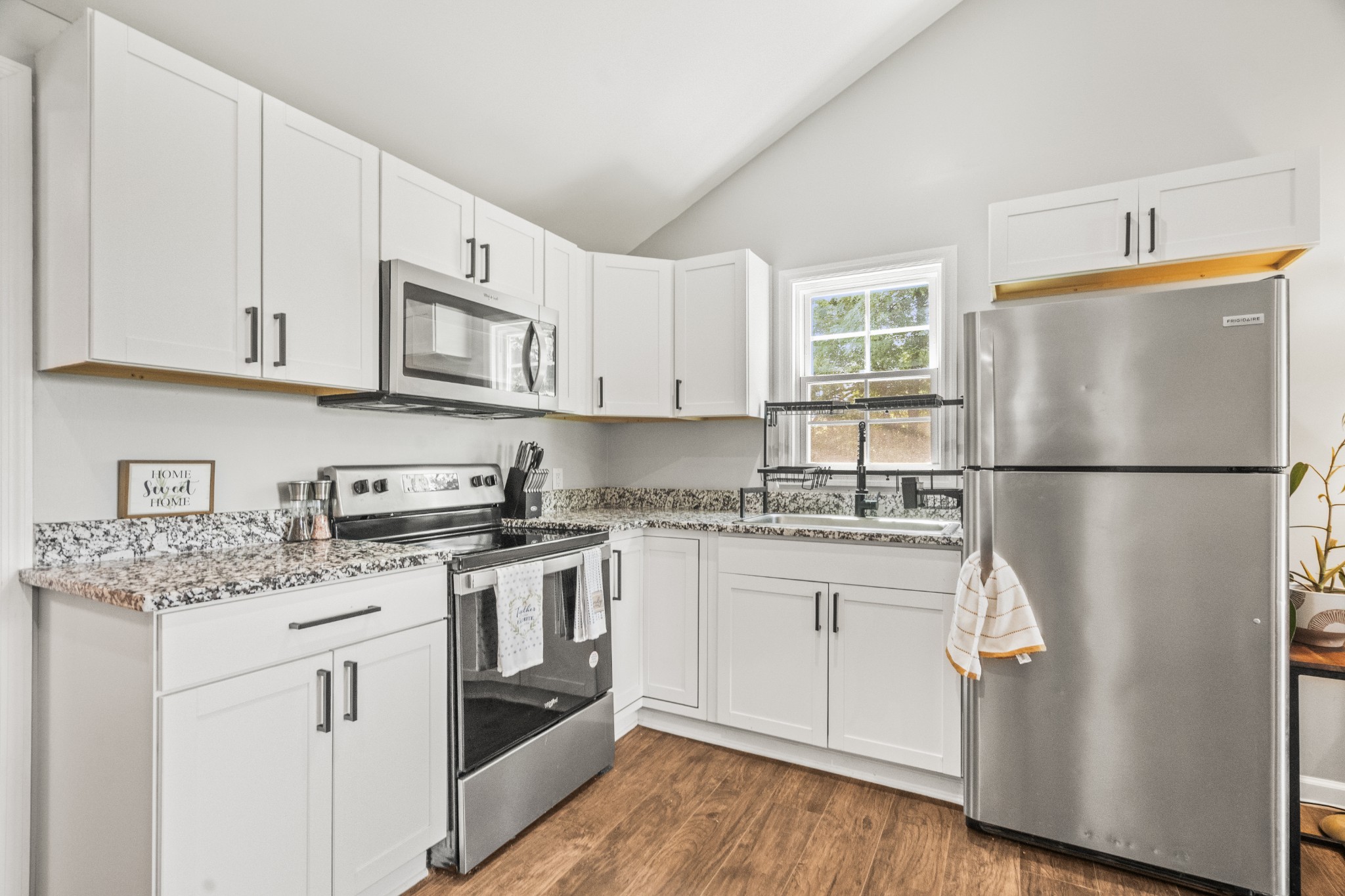 3240 Academy Road Portland, TN 37148 - Photo 13 of 39 a kitchen with stainless steel appliances granite countertop a refrigerator sink and cabinets