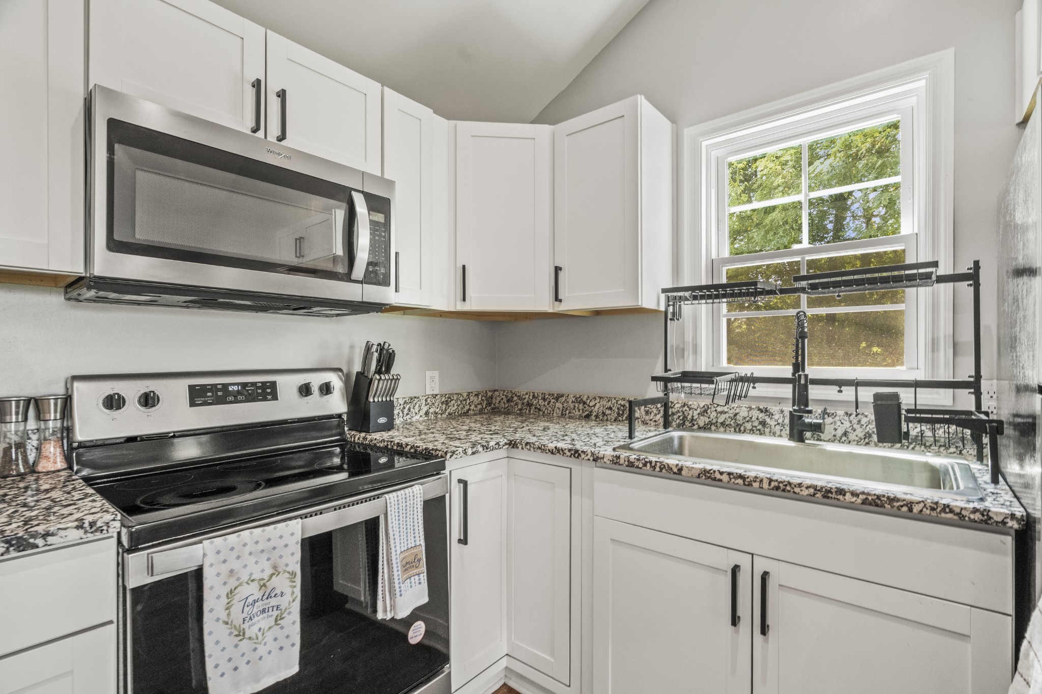 3240 Academy Road Portland, TN 37148 - Photo 14 of 39 a kitchen with granite countertop a sink stove and microwave