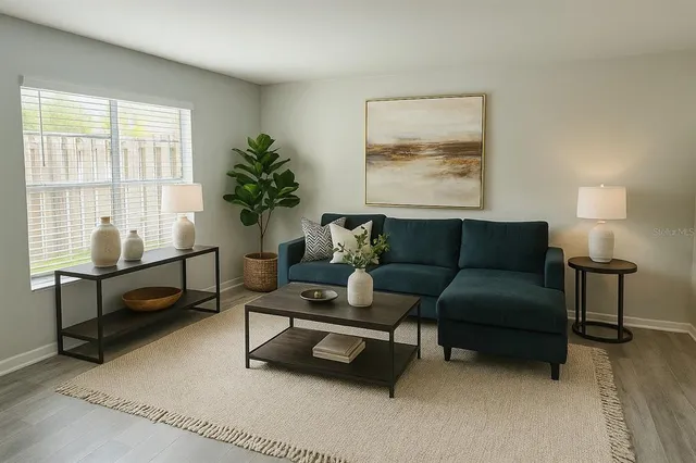 a living room with furniture and a potted plant