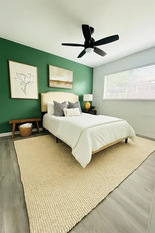 a bedroom with a bed and a large window