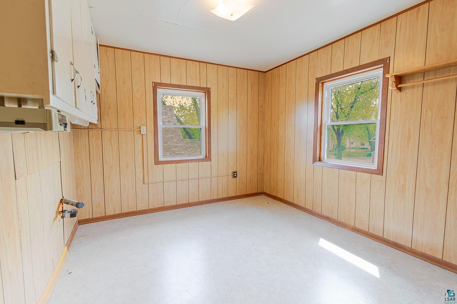 438 9th Street Cloquet, MN 55720 - Photo 22 of 27 Room featuring wood paneling and two windows