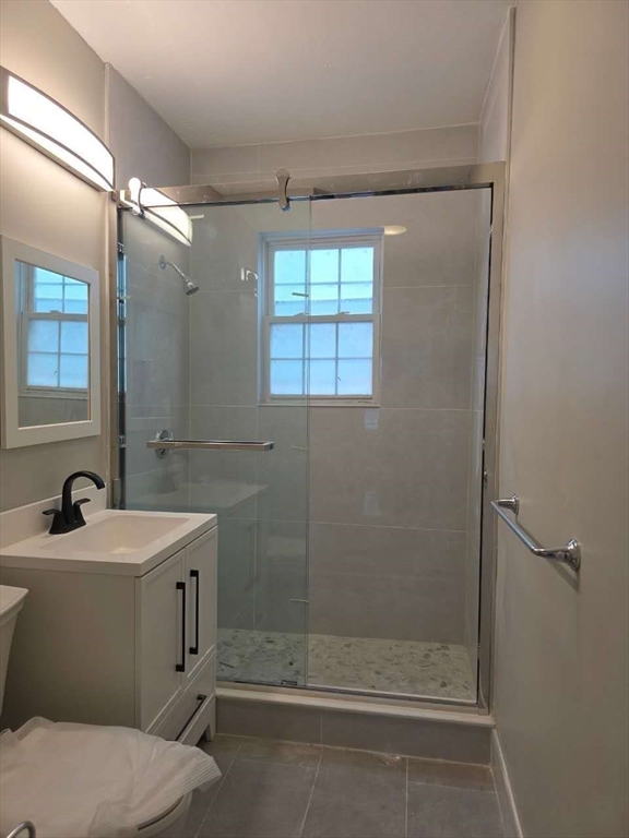 574 Washington Street, Unit 2 Boston, MA 02135 - Photo 10 of 11 a bathroom with a sink toilet and shower
