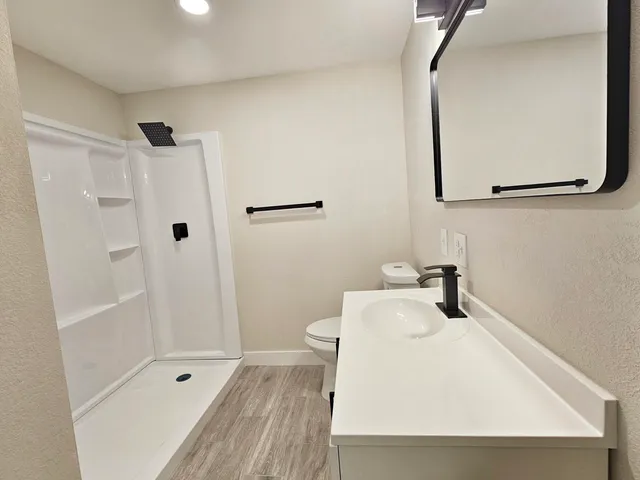 a white toilet sitting next to a bathroom sink