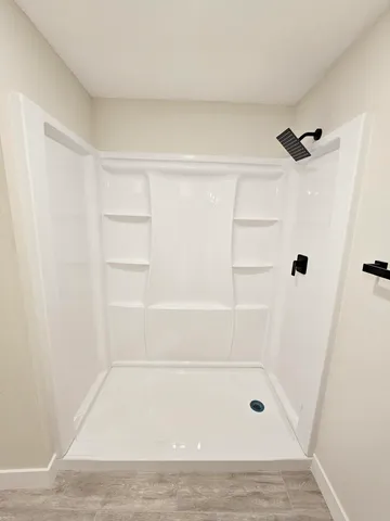 an empty room with a window and a ceiling fan