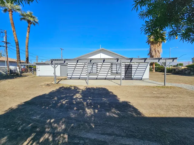a view of a house with palm trees