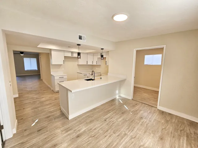 a kitchen with a sink a stove and cabinets
