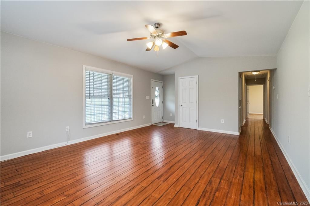 2879 Ranger Road Clover, SC 29710 - Photo 5 of 30 a view of an empty room with wooden floor and a window