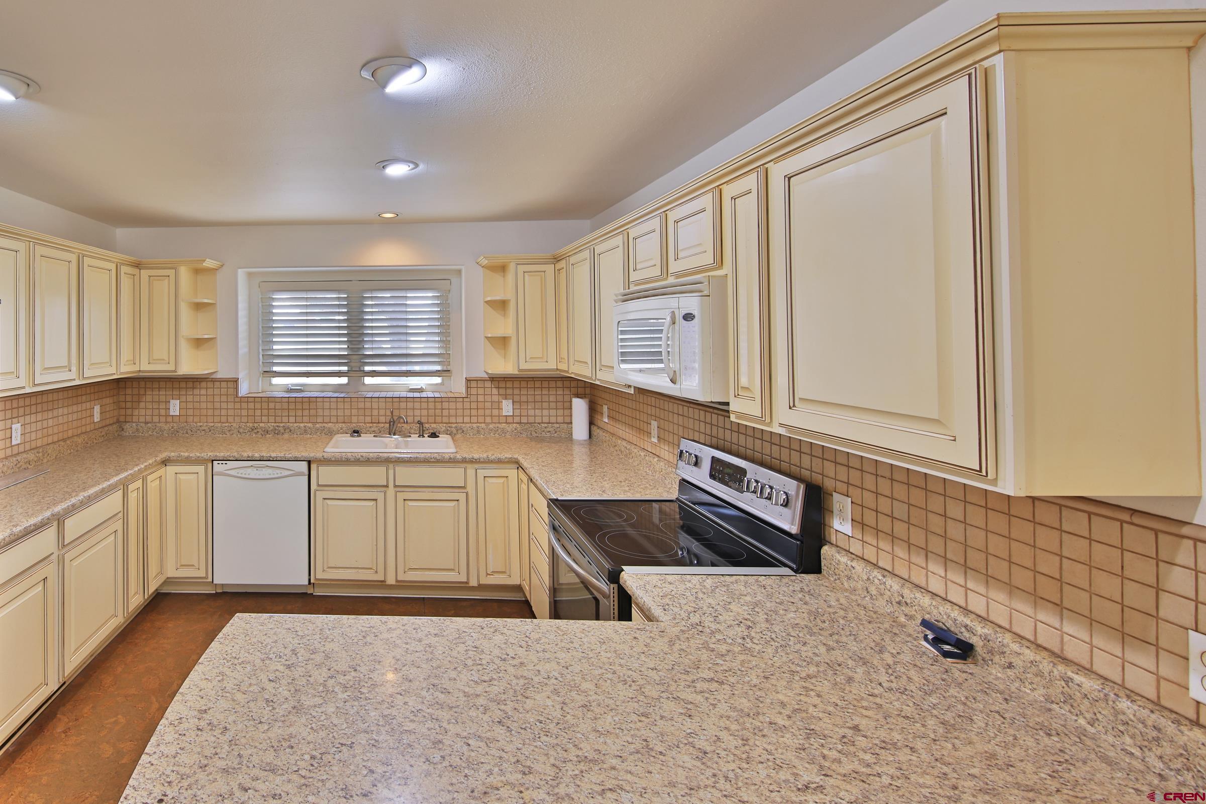 13637 Happy Hollow Road Eckert, CO 81418 - Photo 13 of 38 a kitchen with granite countertop a sink and cabinets