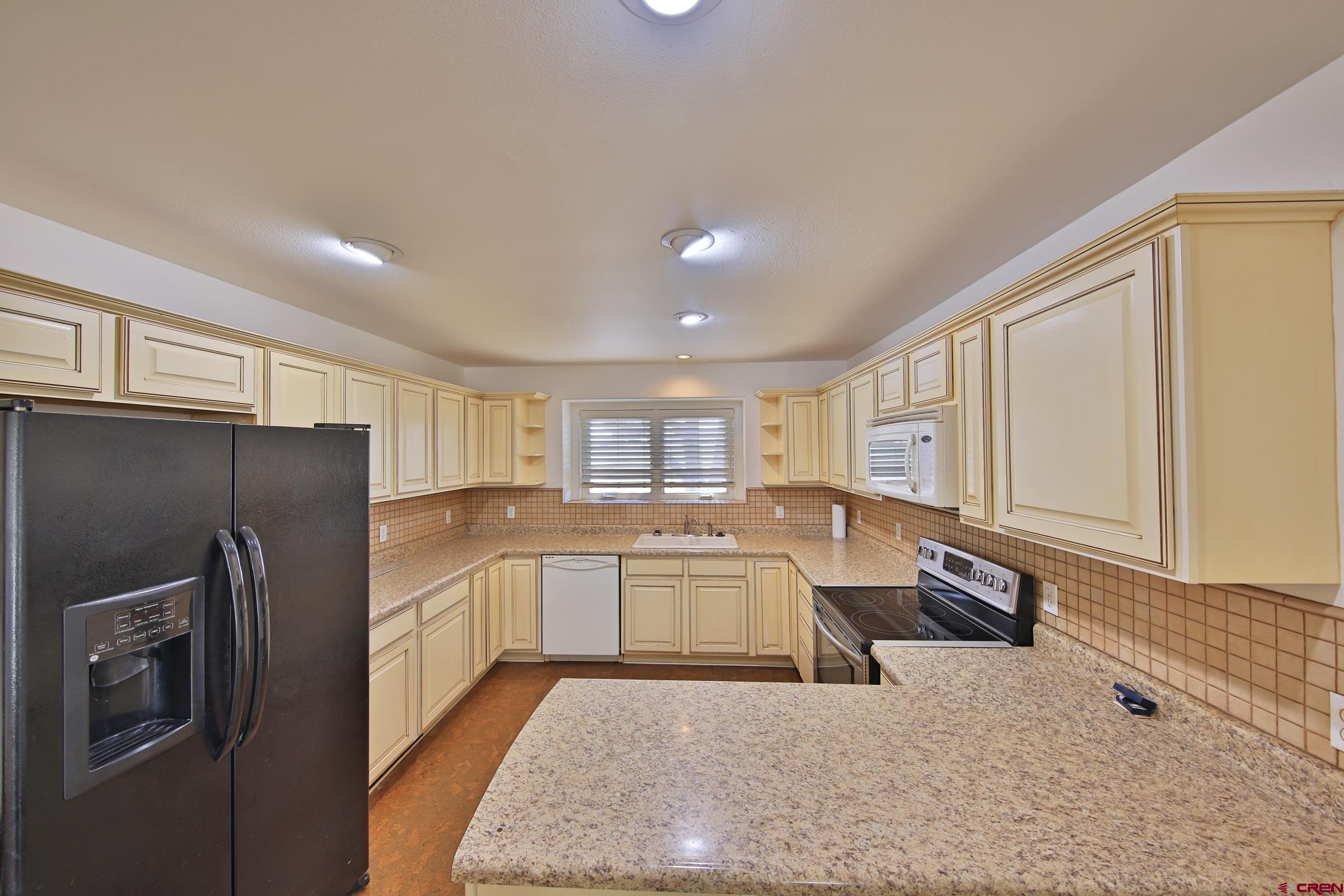 13637 Happy Hollow Road Eckert, CO 81418 - Photo 14 of 38 a large kitchen with kitchen island a sink stainless steel appliances and cabinets
