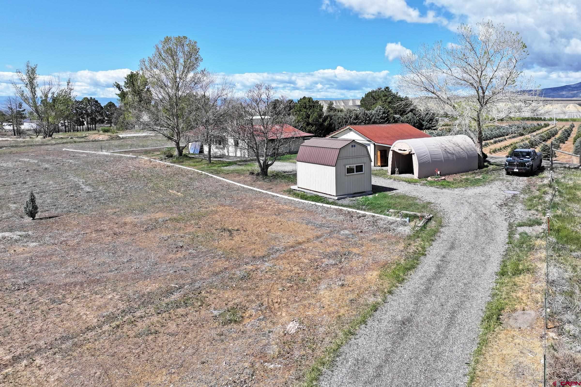 13637 Happy Hollow Road Eckert, CO 81418 - Photo 2 of 38 a view of a yard with cars parked on the road