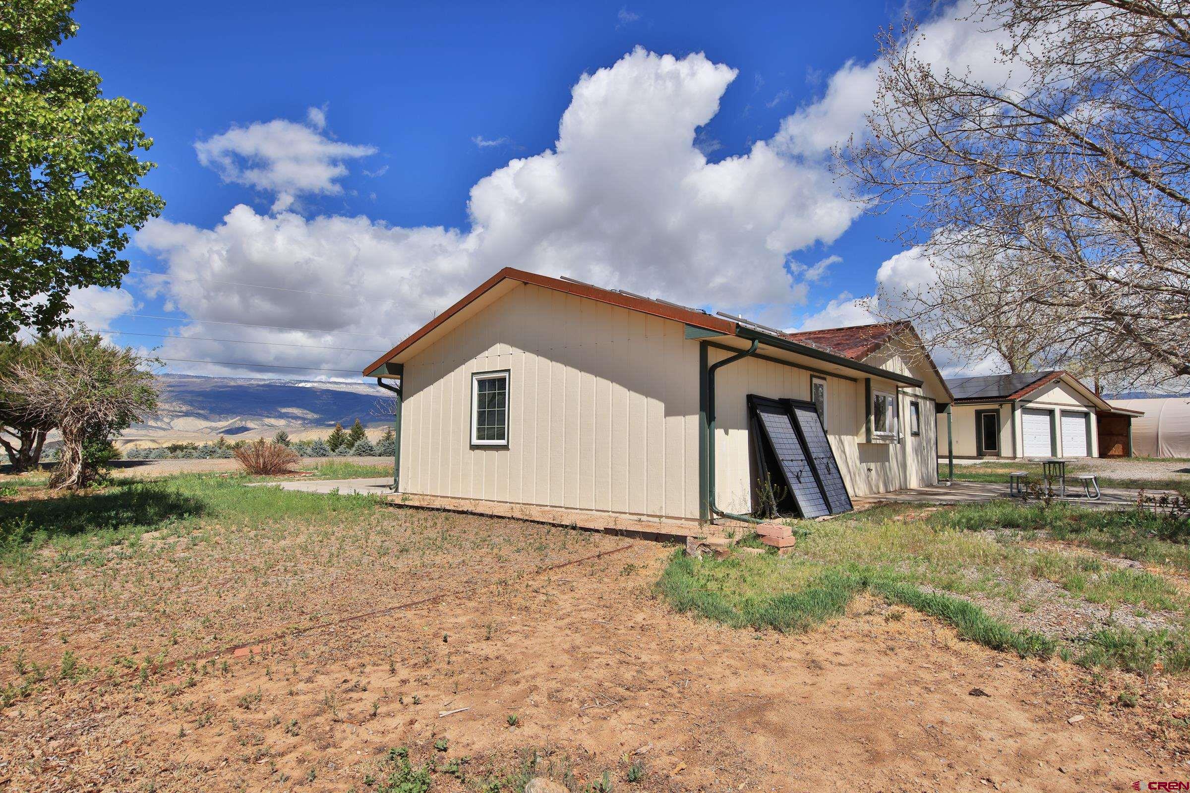 13637 Happy Hollow Road Eckert, CO 81418 - Photo 26 of 38 a view of a house with a yard