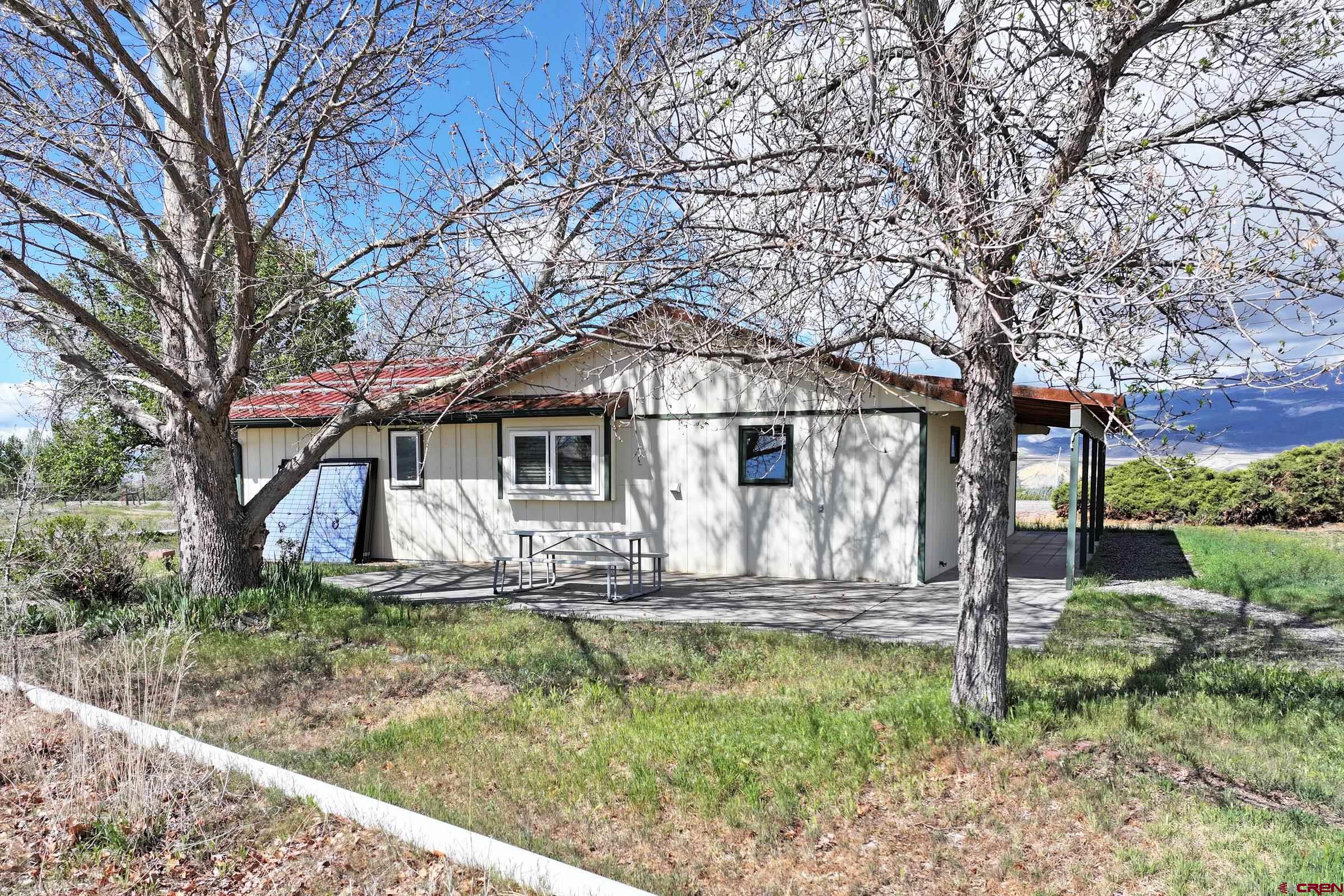 13637 Happy Hollow Road Eckert, CO 81418 - Photo 27 of 38 a front view of a house with garden