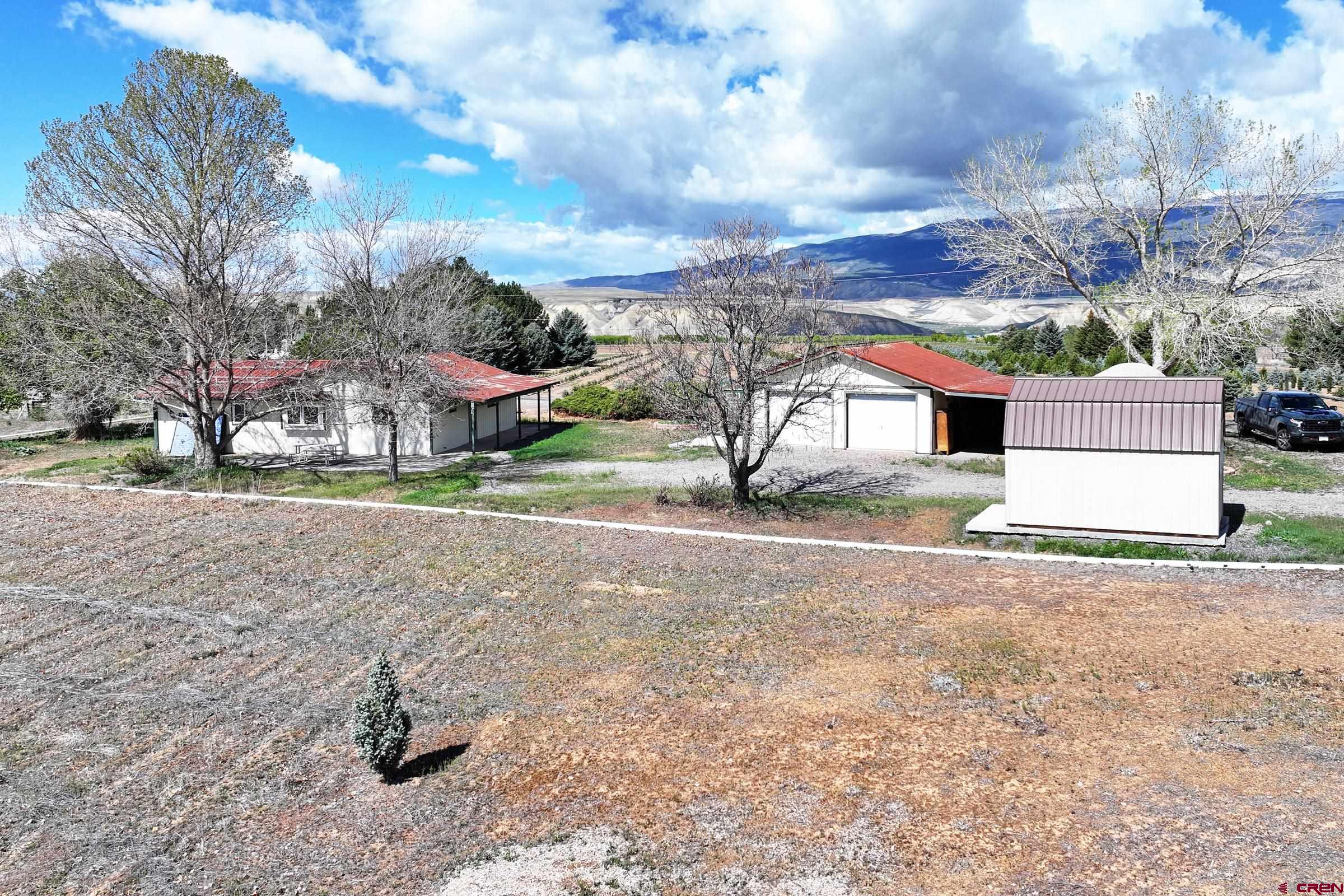 13637 Happy Hollow Road Eckert, CO 81418 - Photo 3 of 38 a view of a house with a yard and garage