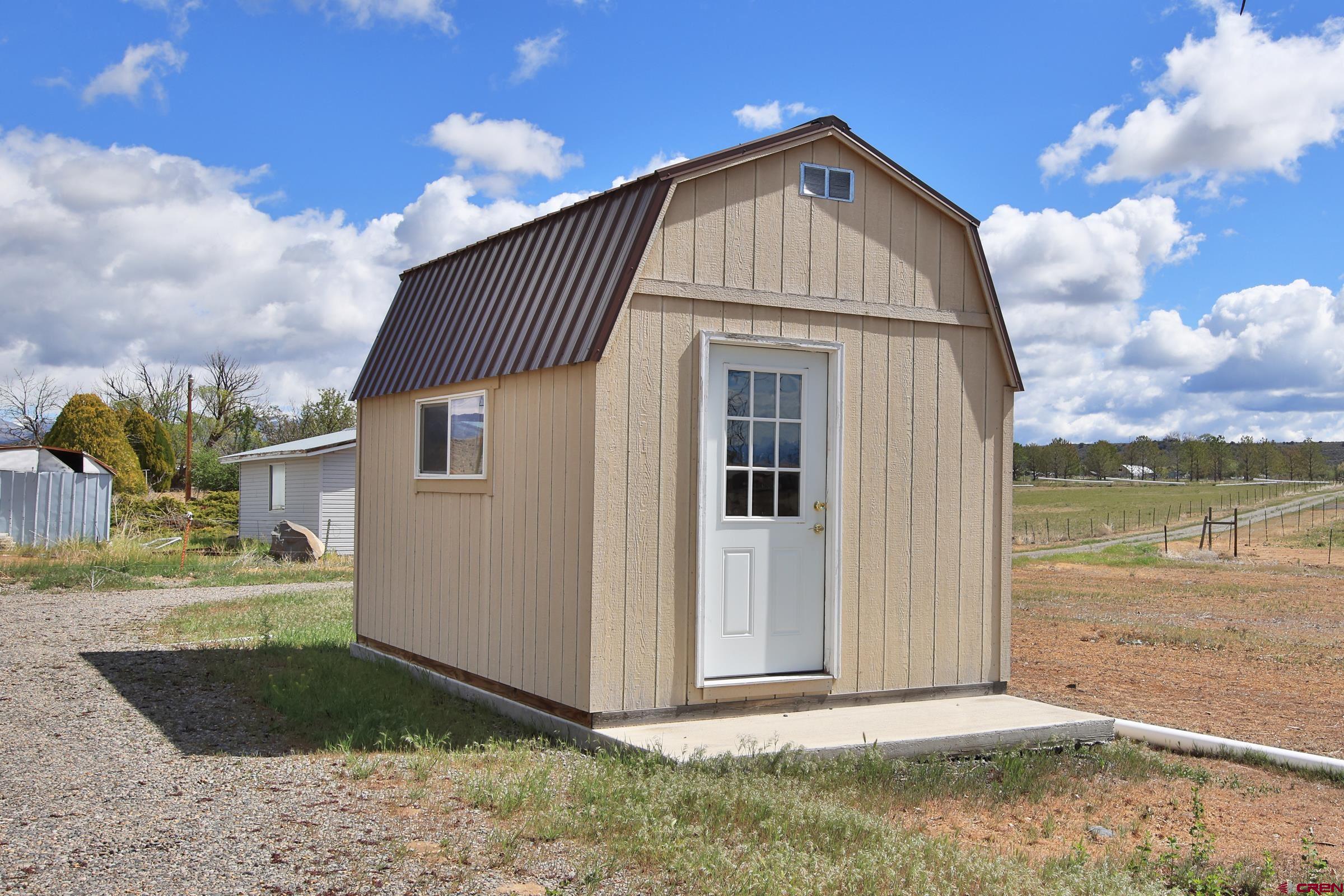 13637 Happy Hollow Road Eckert, CO 81418 - Photo 35 of 38 a front view of a house with a yard