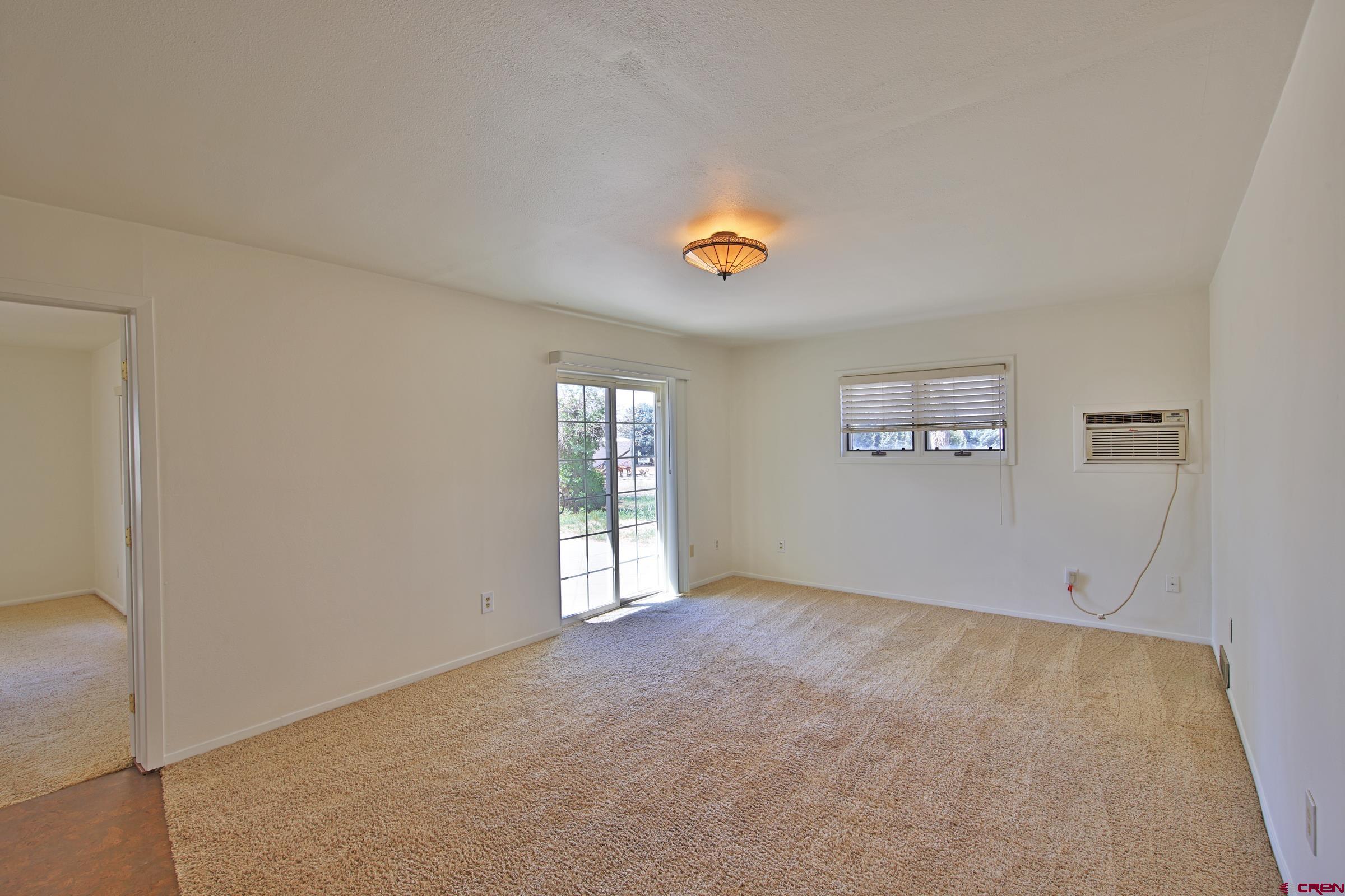 13637 Happy Hollow Road Eckert, CO 81418 - Photo 9 of 38 an empty room with windows and ceiling fan