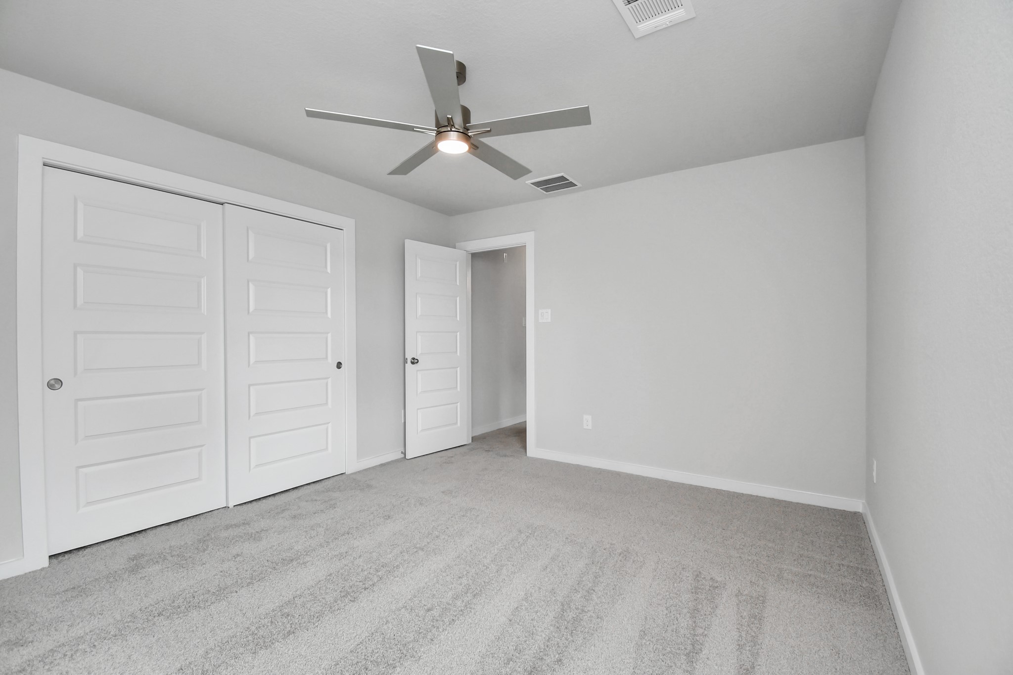 3043 Native Spg Drive Spring, TX 77373 - Photo 35 of 39 Secondary bedroom features plush carpeting, large windows that let in plenty of natural light, bright paint, and spacious closets. Sample photo of completed home with similar floor plan. Actual colors and selections may vary.