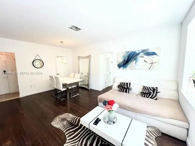 a bedroom with furniture and a wooden floor