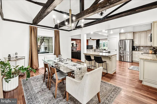 a bathroom with a granite countertop double vanity sink and mirror