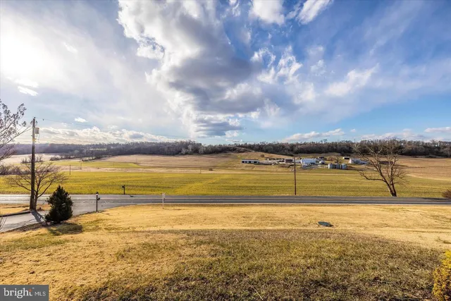 a living room with furniture a flat screen tv and wooden floor