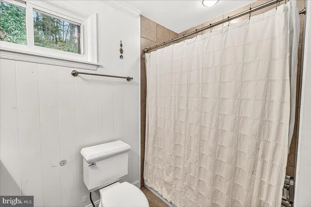 a view of backyard with seating space and trees