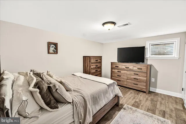 a view of backyard with table and chairs and wooden fence