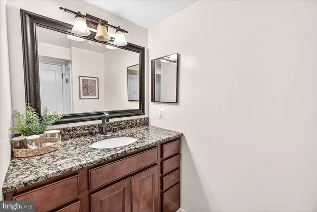 a view of a tree in front of a house with a yard