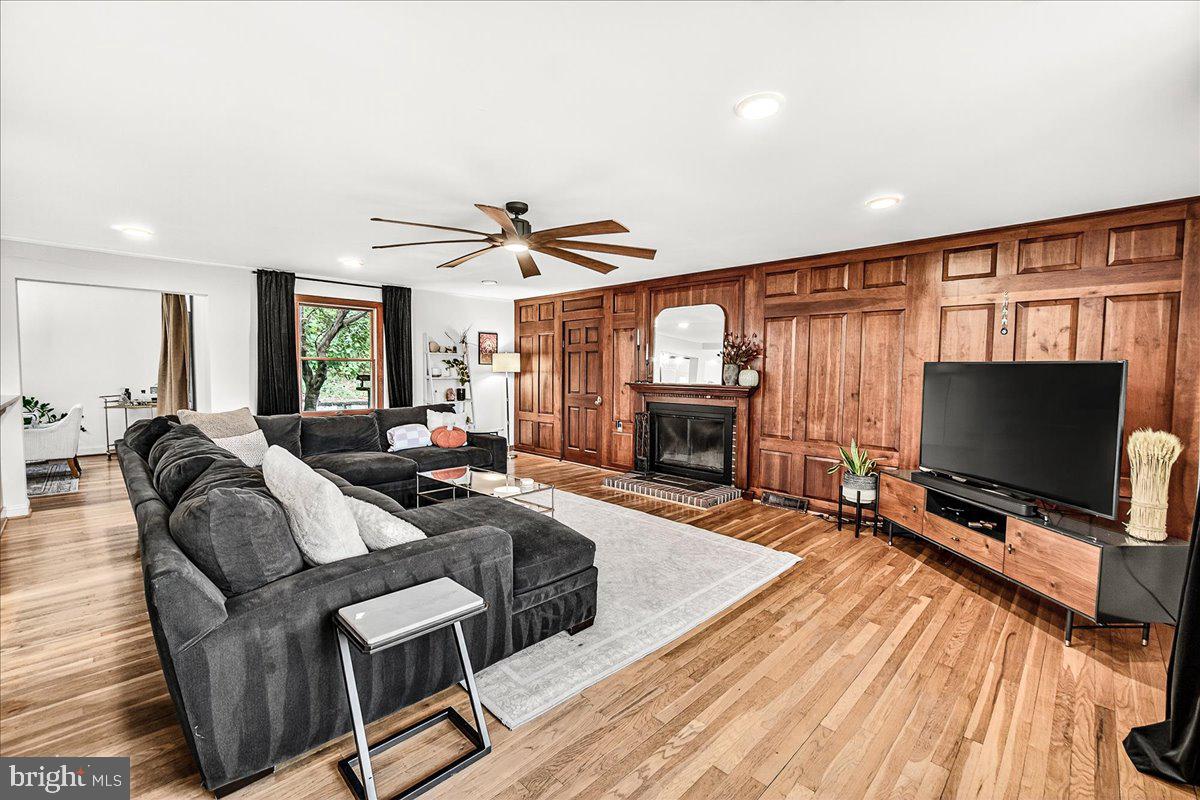 3913 Baker Valley Road Frederick, MD 21704 - Photo 3 of 105 a living room with furniture a flat screen tv and wooden floor