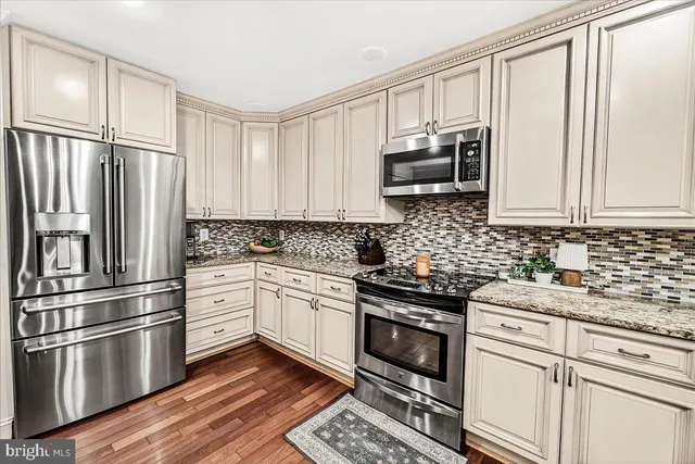 a bedroom with a bed flat screen tv and a large window