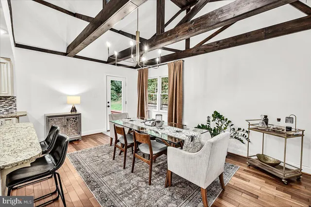 a bedroom with a bed a couch and a chandelier