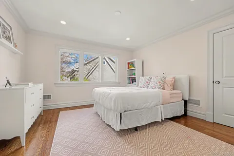 a spacious bedroom with a bed and a large window