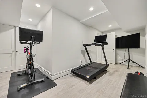 a room with gym equipment and a flat screen tv
