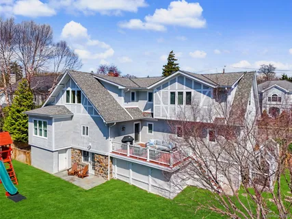 a front view of a house with a garden and plants