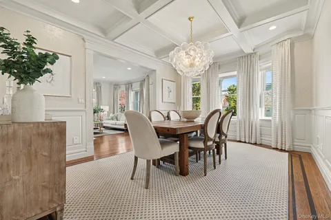 a view of a dining room with furniture and a chandelier