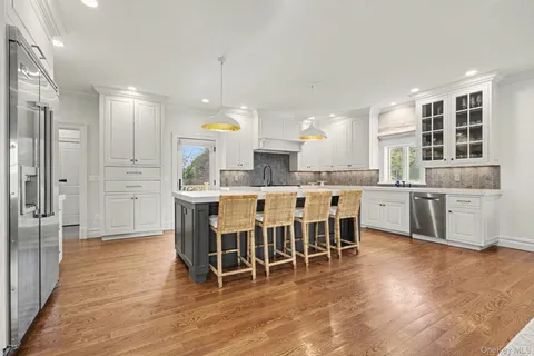 a large kitchen with a table and chairs