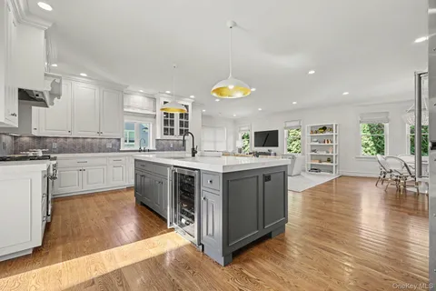 a kitchen with a sink cabinets and wooden floor