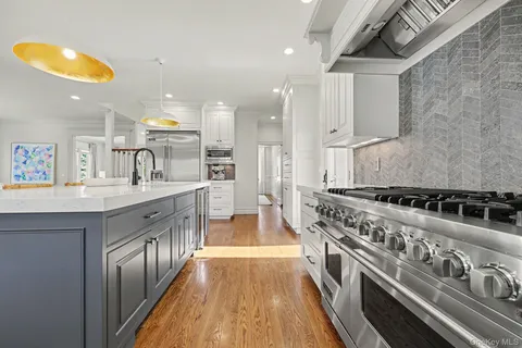a open kitchen with stainless steel appliances granite countertop a stove and a sink