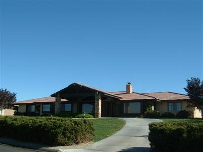 13475 Delaware Road Apple Valley, CA 92308 - Photo 1 of 1 a front view of a house with a yard