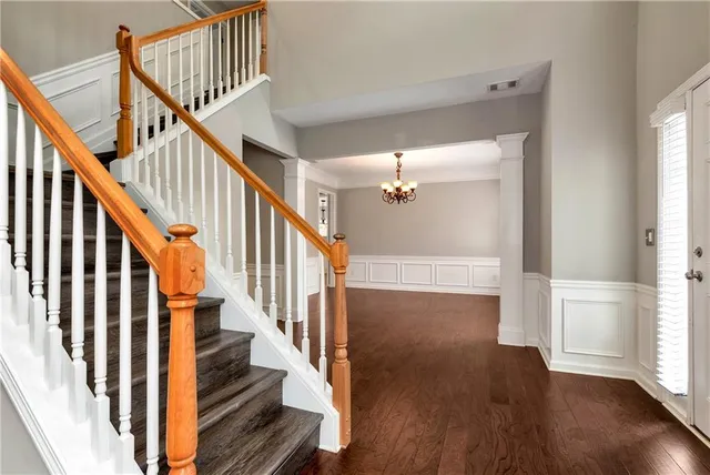 a view of an entryway with wooden floor and stairs