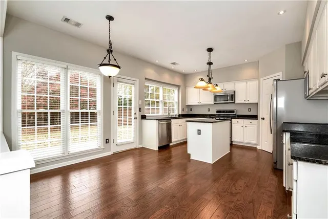 a view of wooden floor and windows in a room