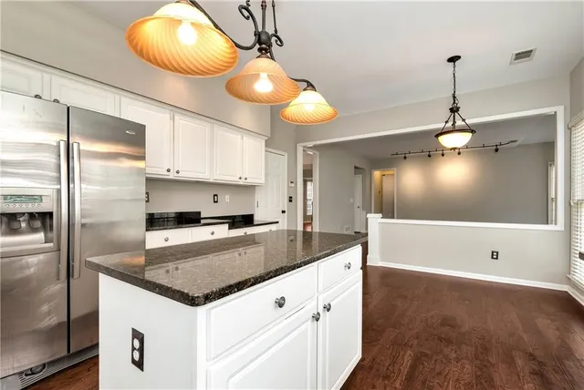 a view of a livingroom with wooden floor and windows