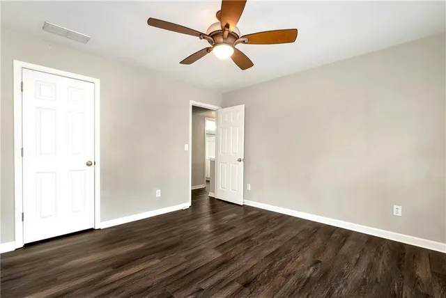 a view of a house with a yard and large tree