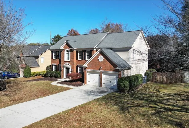 a front view of a house with a yard and garage